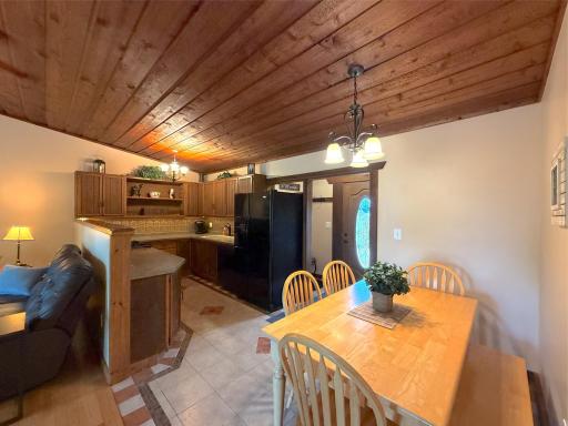 Enjoy casual dining just steps from the kitchen, where warm wood accents and an open layout complement the home's inviting log home character.