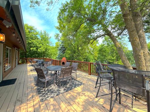 Entertain in style on the expansive lakeside deck, offering multiple seating areas, mature shade trees, retractable awning and peaceful views of Ramsey Lake.