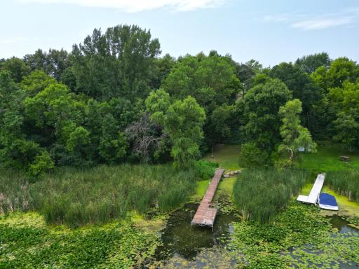 Towering mature trees create a private lakeside setting, with a dock extending out to the peaceful waters of Ramsey Lake. Enjoy the beauty of nature right outside your door.
