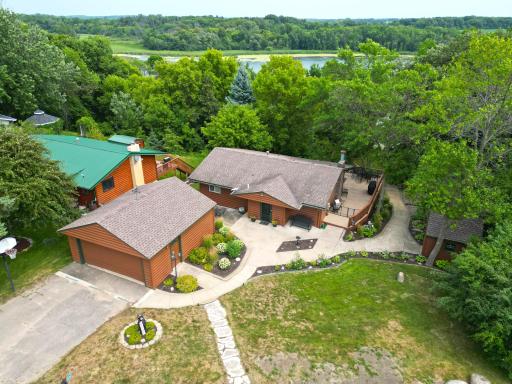 Beautifully landscaped and tucked into the trees, this Ramsey Lake home combines rustic charm with spacious indoor and outdoor living designed to embrace the lake views.