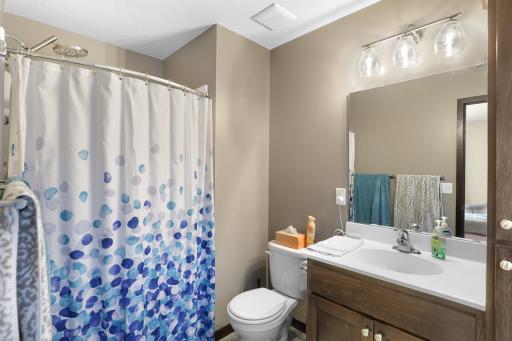 Private primary bathroom with linen cabinet as well