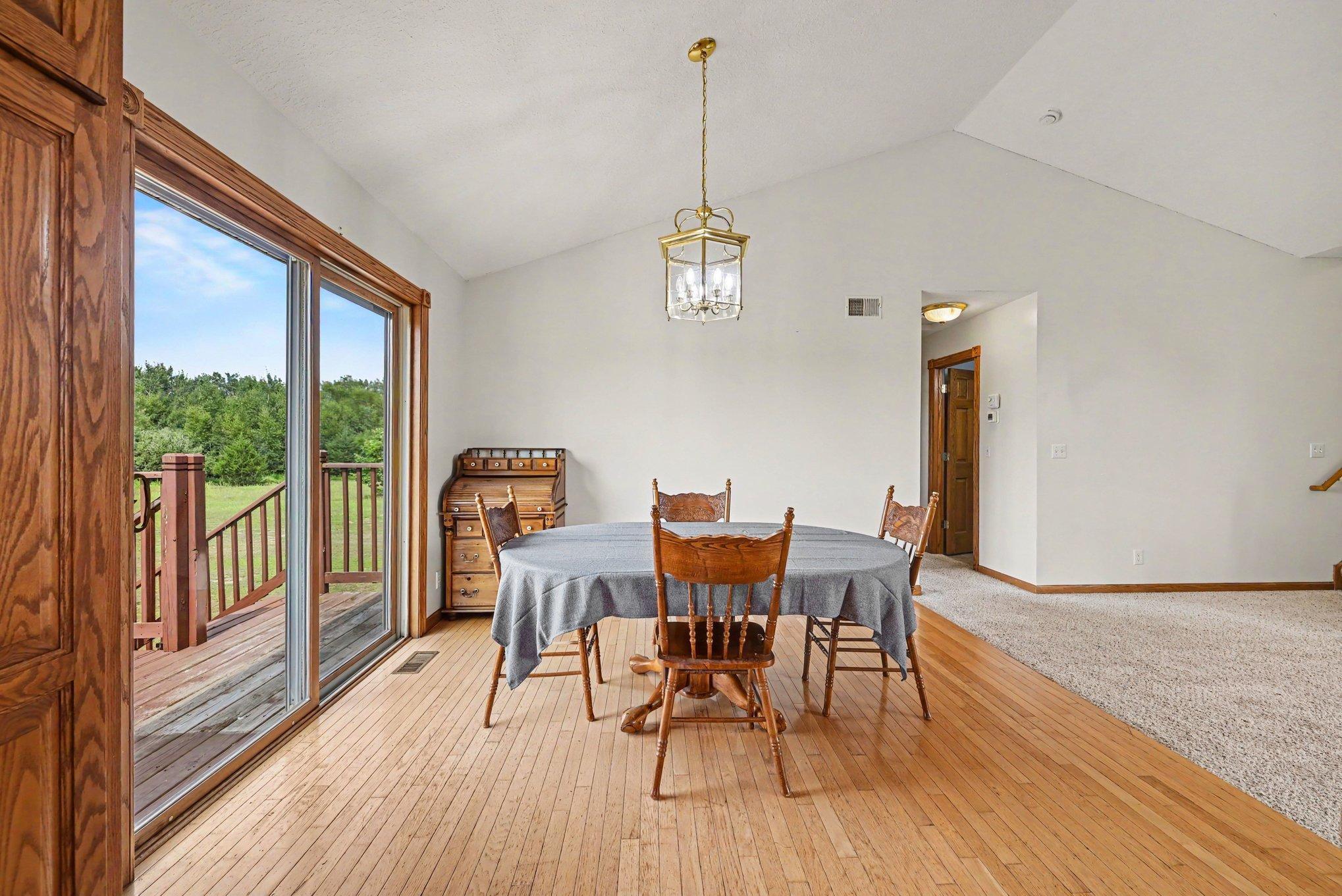 Bright dining area with access to the deck and beautiful views of the surrounding property.