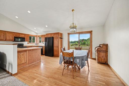 Open dining area flows seamlessly into the kitchen, with beautiful views of the surrounding property.