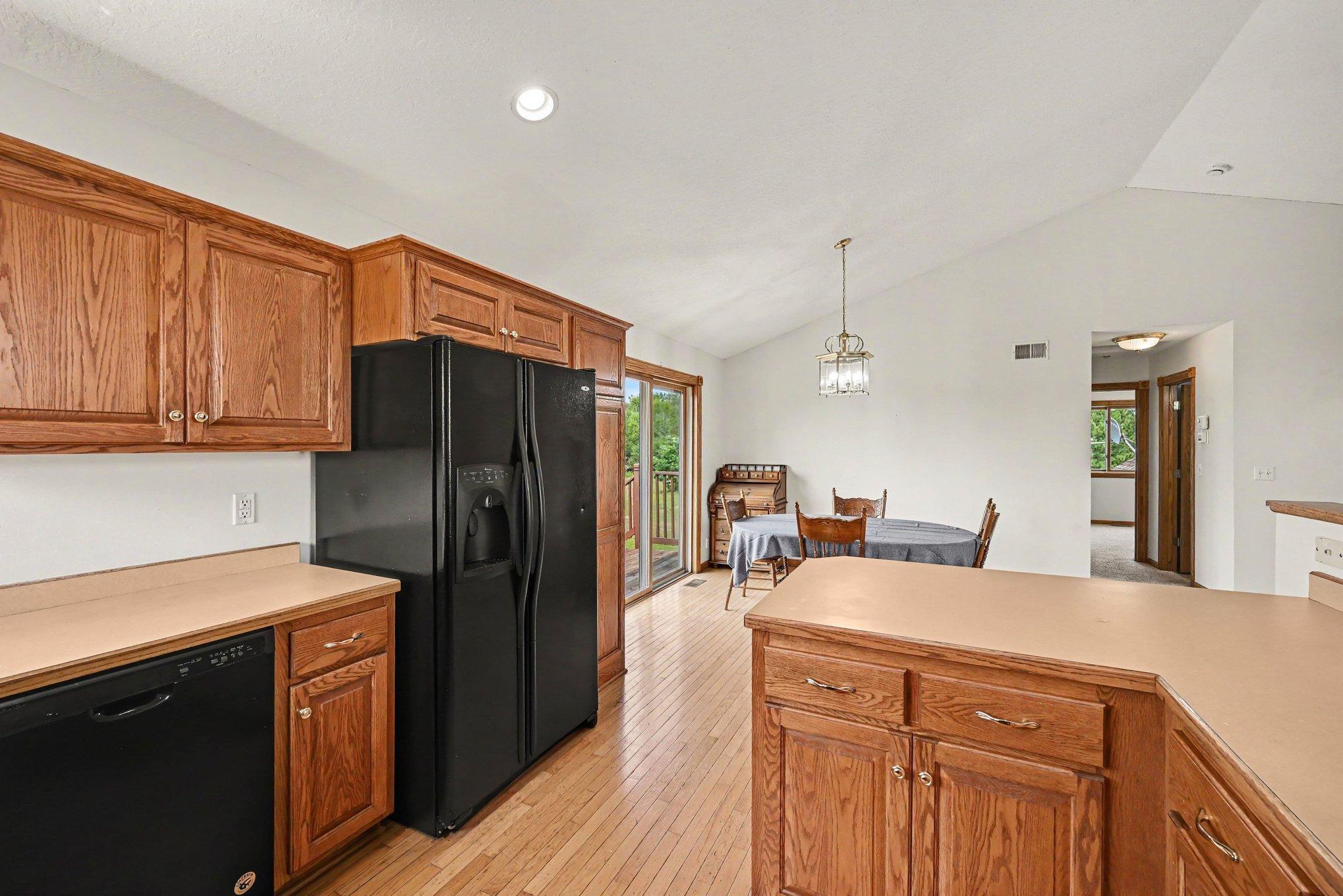 Spacious kitchen with abundant cabinetry, generous counter space and an open view into the dining area.