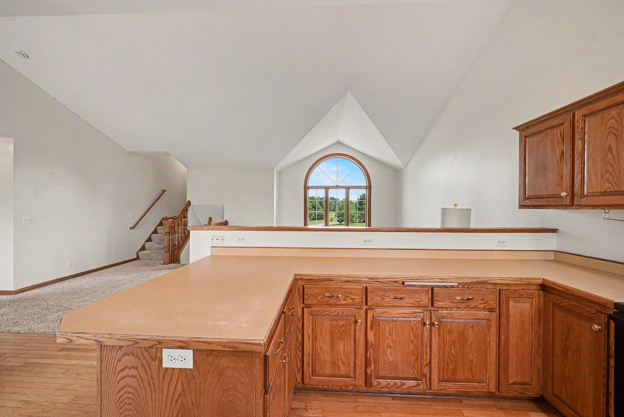Expansive kitchen peninsula provides additional counter space and opens to the main living area.