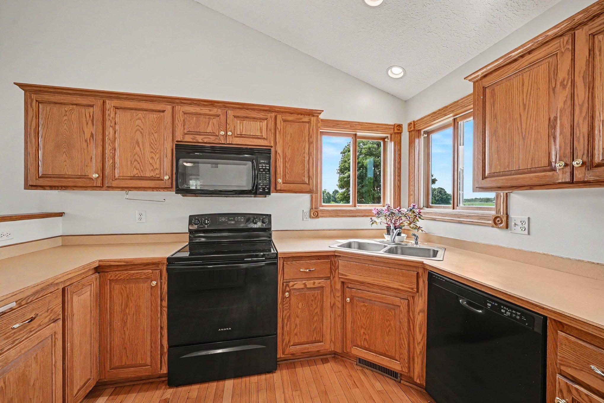 Kitchen features plenty of cabinet and counter space, plus windows overlooking the peaceful country setting.
