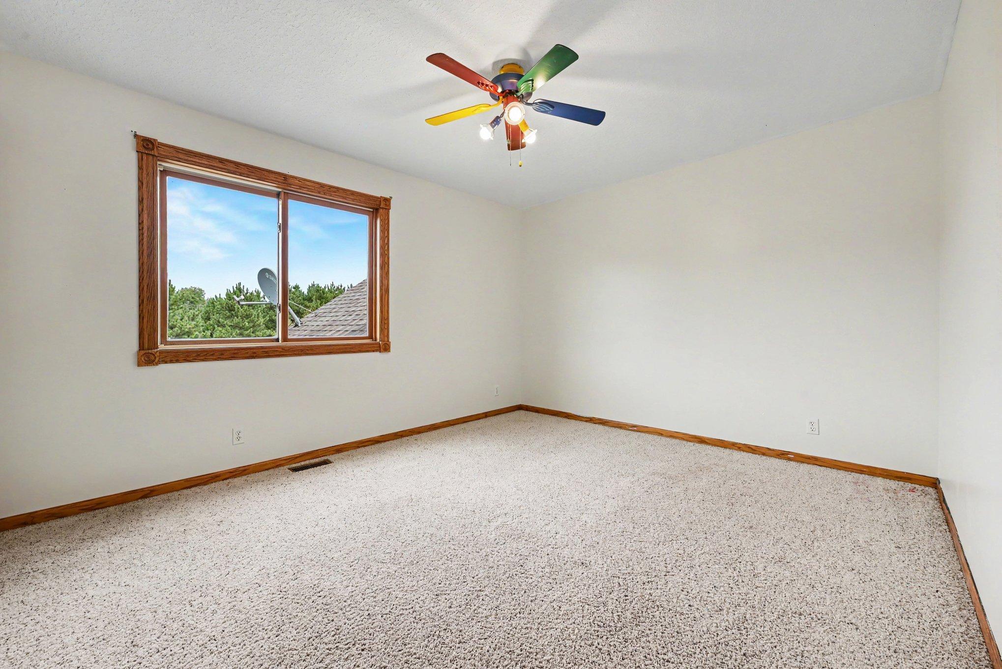Main-level bedroom #2 with natural light and views.