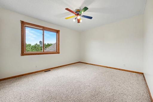 Main-level bedroom #2 with natural light and views.