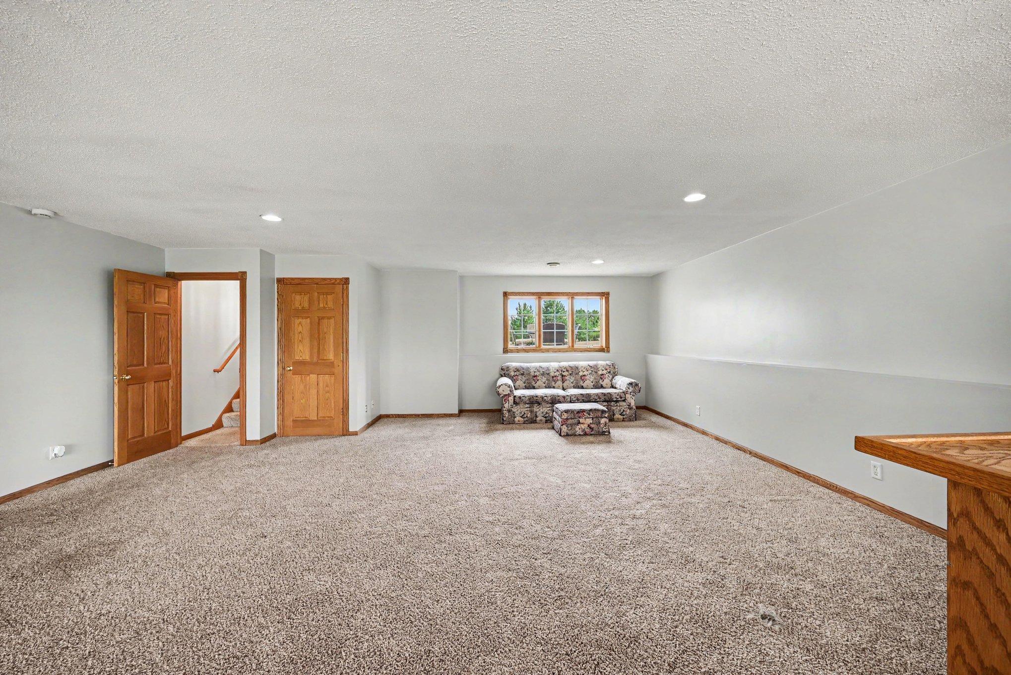 Additional view of the expansive lower-level family room with plenty of room for entertaining, recreation or relaxation.