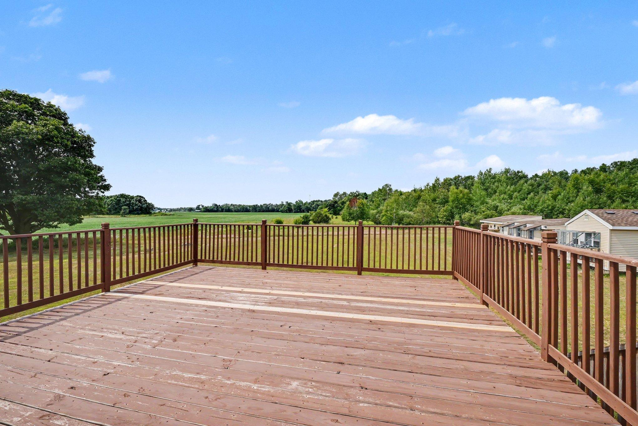 Expansive deck overlooking the peaceful country setting and surrounding acreage.