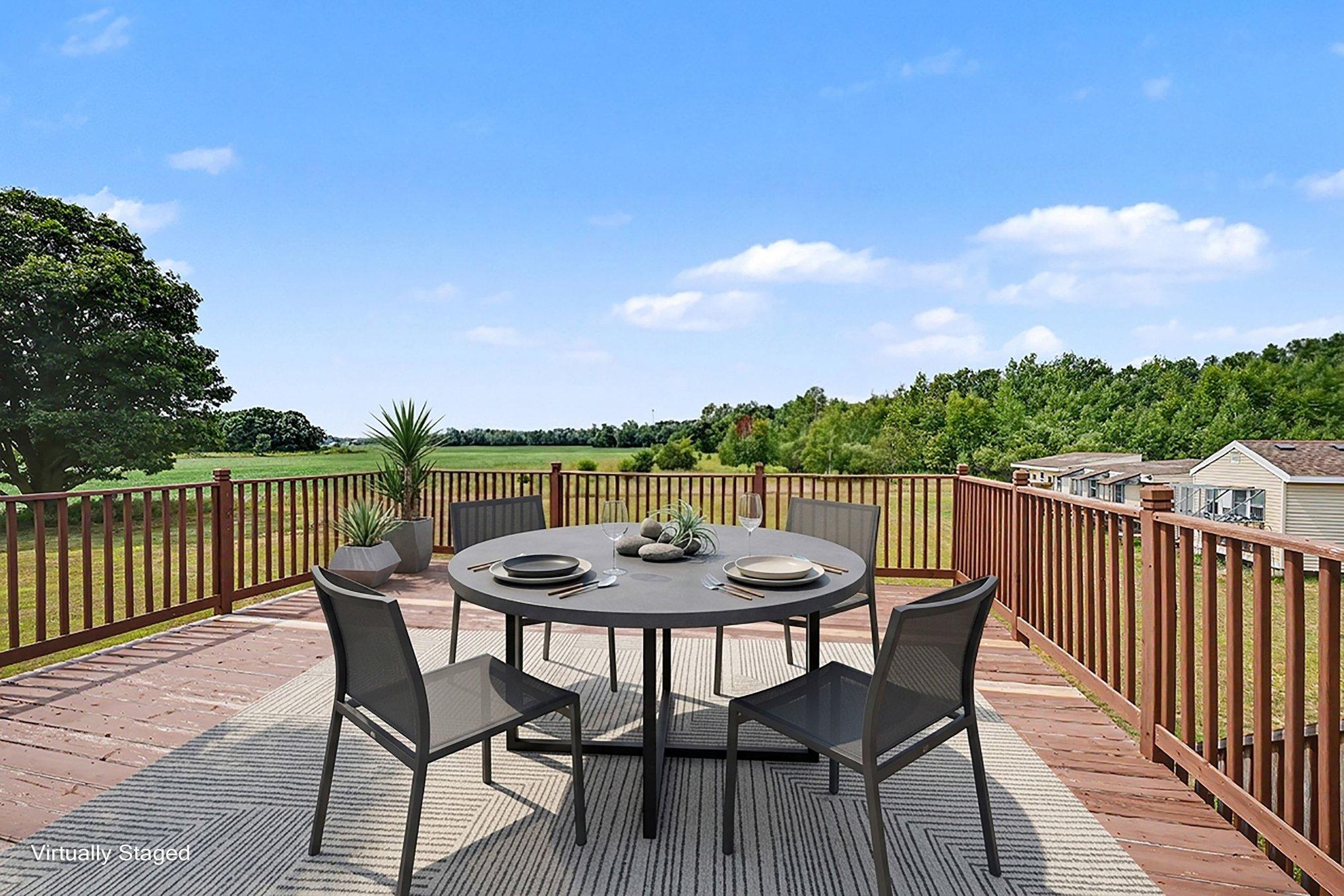 Spacious deck offers plenty of room for outdoor dining, entertaining and enjoying the views. Virtually staged.