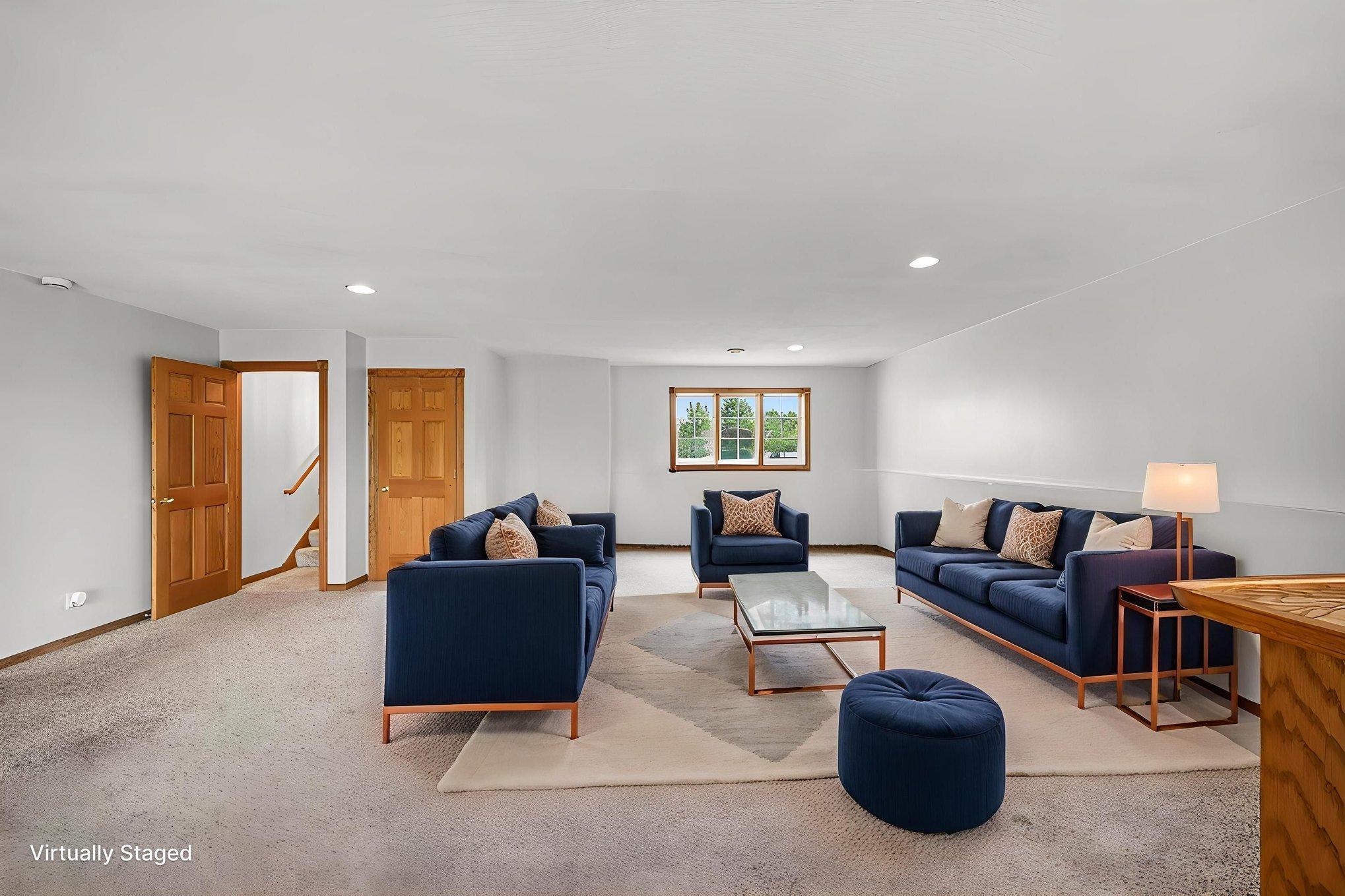 Lower-level family room, virtually staged to showcase the possibilities for this spacous gathering area.
