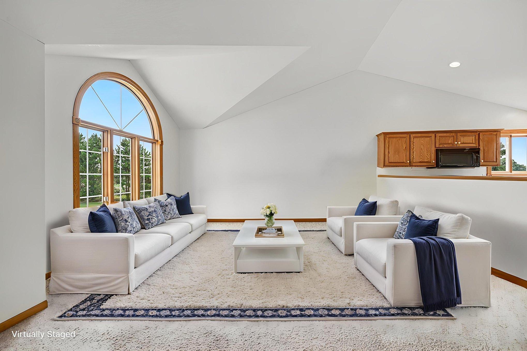 Bright and inviting living room with abundant natural light and plenty of space for gathering. Virtually Staged.