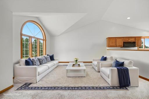 Bright and inviting living room with abundant natural light and plenty of space for gathering. Virtually Staged.