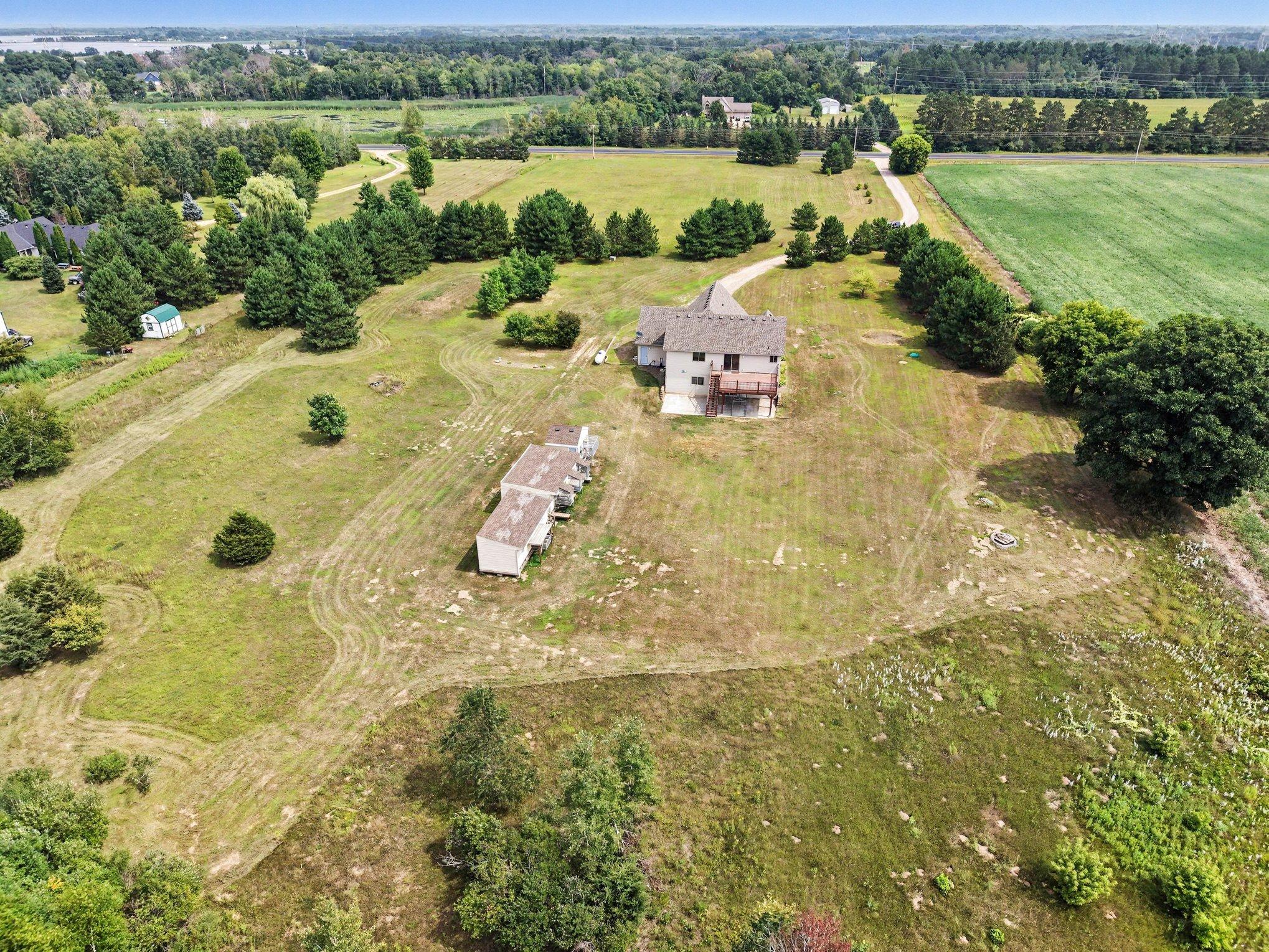 Bird's-eye view of the home and expansive acreage, offering plenty of possibilities for outdoor enjoyment.