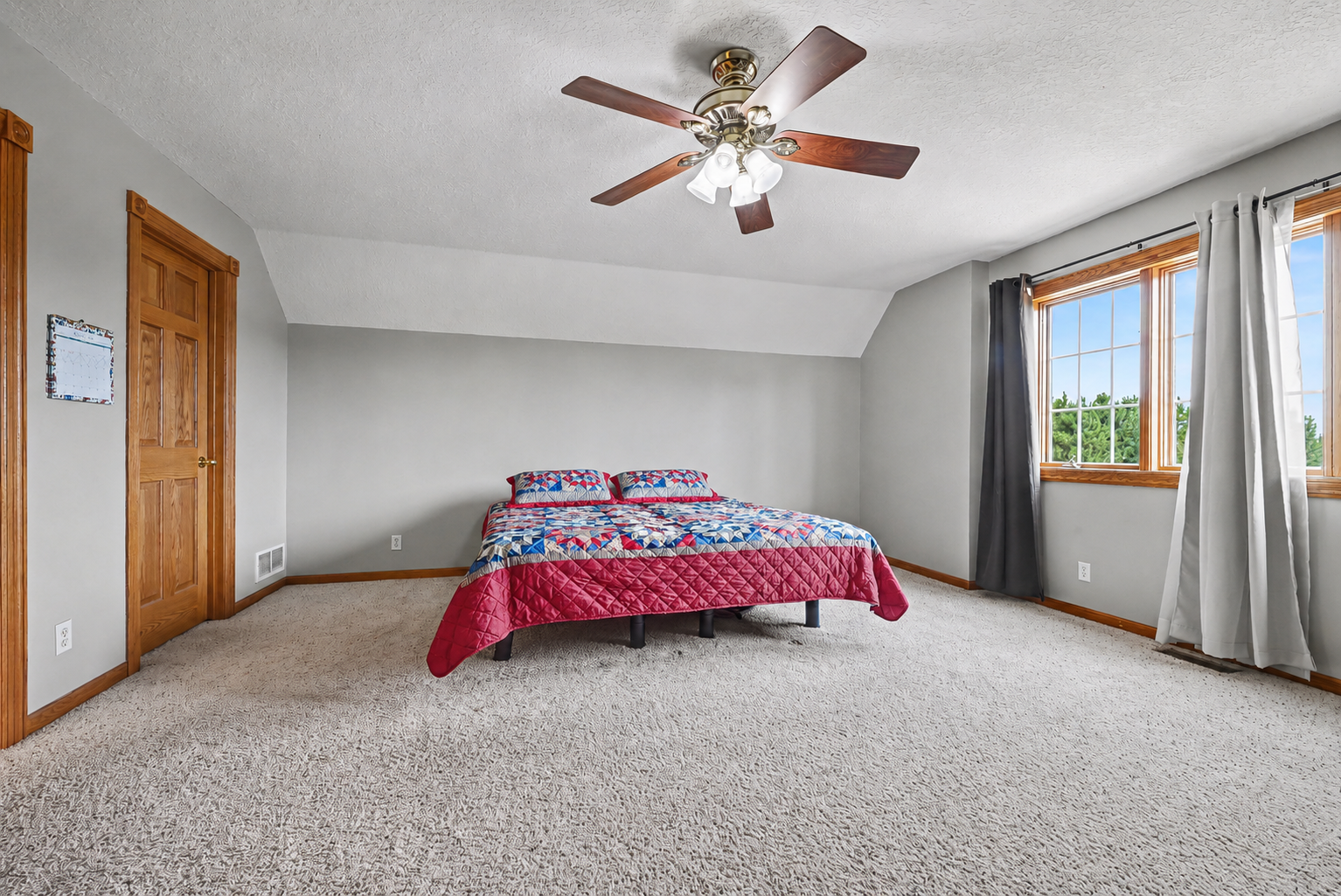 Primary bedroom featuring a generous walk-in closet, abundant natural light and private ensuite bath.