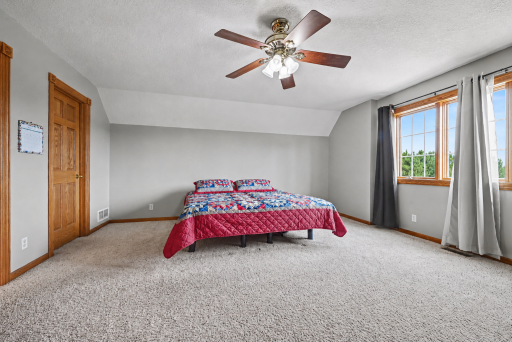 Primary bedroom featuring a generous walk-in closet, abundant natural light and private ensuite bath.