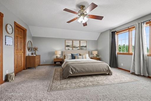 Primary bedroom virtually staged to showcase the generous size of the primary bedroom and its potential for a comfortable, inviting retreat.
