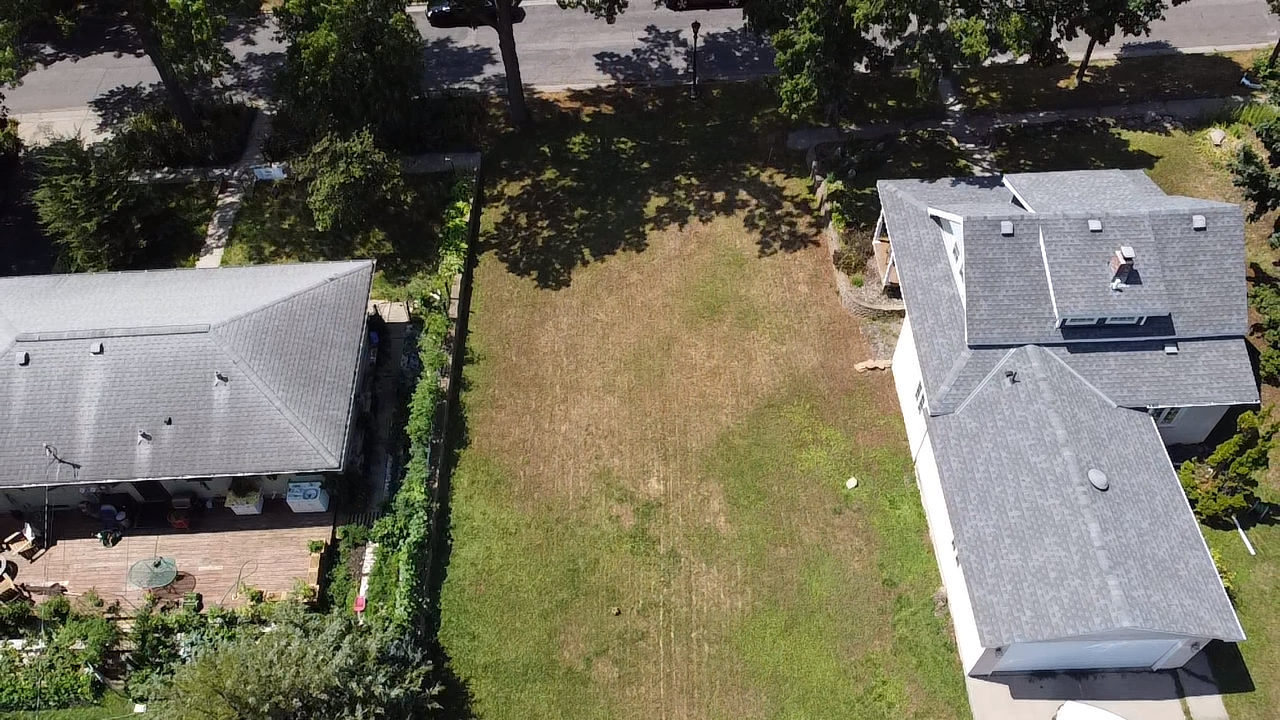 The lot is on a beautiful, tree-lined street and walkable to many quaint, locally owned restaurants and shops.