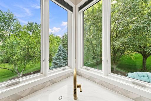 Who doesn't LOVE a corner kitchen sink window overlooking your back patio and yard? This is also a nice close up of the Italian custom tile backsplash