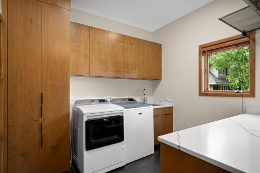 Upper Level Laundry Area w/Built Ins and a Large Storage Area.