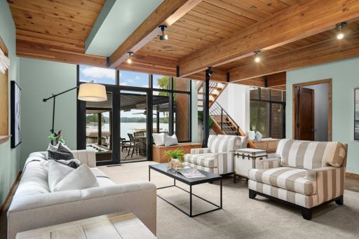 Main Floor Living Room featuring Wood & Beamed Ceilings and Walk Out to Deck & Lakeshore.