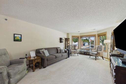 The living room features a bay window to bring in natural light.