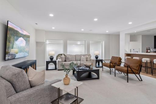 22' x 21' Lower level family room overlooking the sport court and golf simulator room