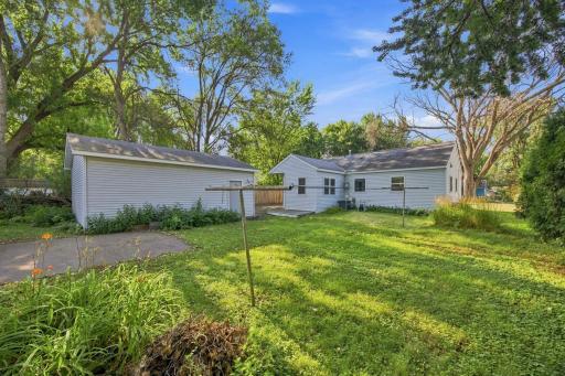 awesome back yard with concrete patio, solar dryer and west side lined with cedar trees.