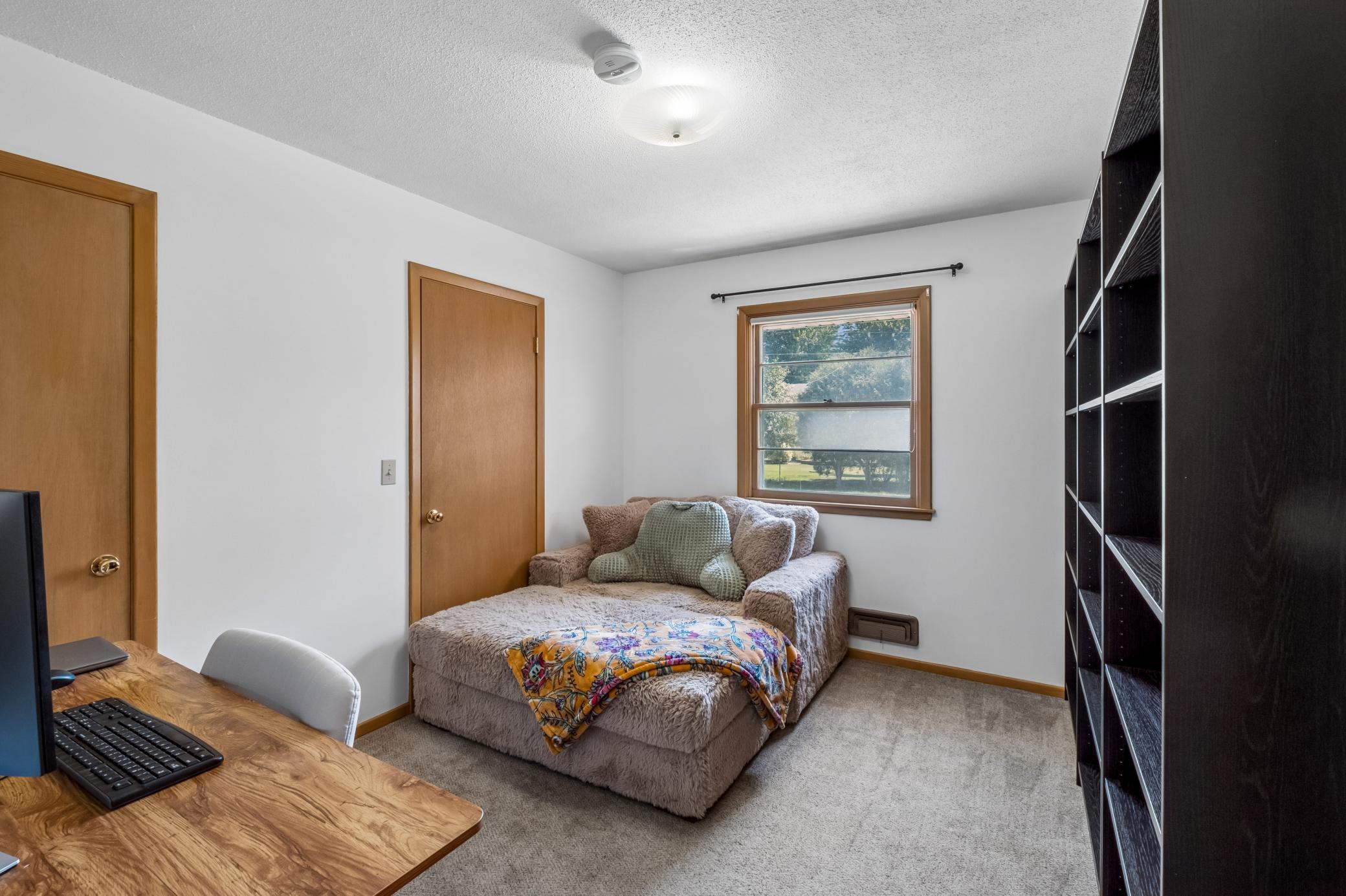 Bedroom 3 of 4, main floor. This room could also be a formal dining room as it can open to the kitchen.