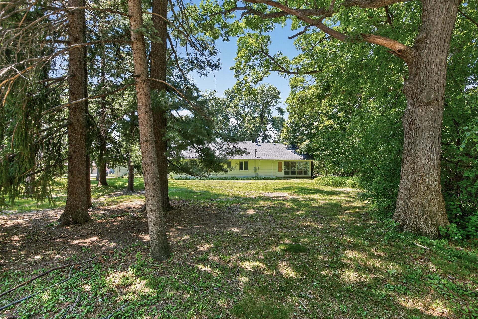 Live peacefully on this large wooded lot in the city!