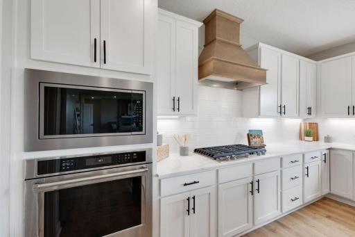 This upgraded Gourmet kitchen is sure to bring the family chef a sense of pride and JOY! Model photo, options and colors may vary.