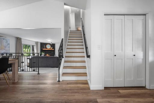 Step inside to a light-filled foyer featuring modern LVP flooring, crisp white trim, and sleek black accents. The open staircase. Fabulous updates create an inviting first impression while offering a glimpse into incredible design throughout.