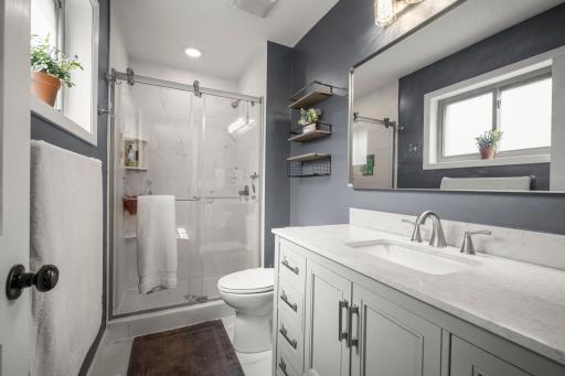 Updated, primary bathroom! Quartz countertops, large vanity and tiled shower and floors.
