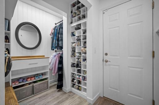 Impressive mudroom with a spacious closet makes staying organized effortless.