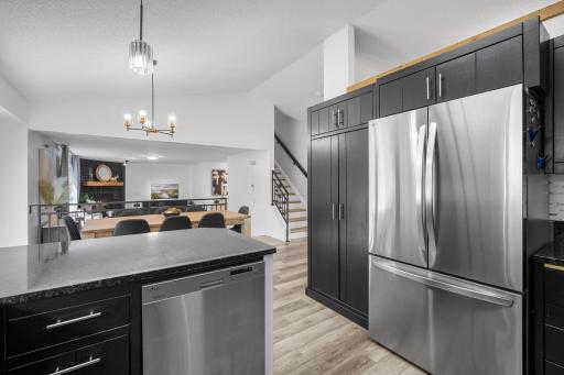 Exceptional kitchen updates include timeless black cabinetry, Granite countertops, Stainless Steel appliances, and a designer-inspired tiled backsplash.