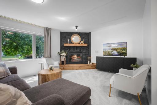 Elegant stone fireplace features an updated mantel creates a timeless focal point of the main level living space.