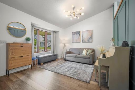 Modern, neutral finishes throughout complement the vaulted main-level living room, creating a bright and welcoming open floor plan.