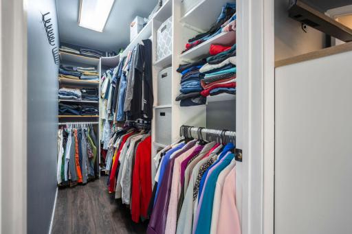 Walk in closet with great organization and shelving!