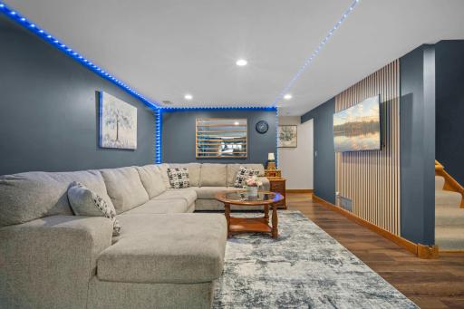 Incredible finished lower level featuring crisp, modern finishes and stylish wall panel accents.