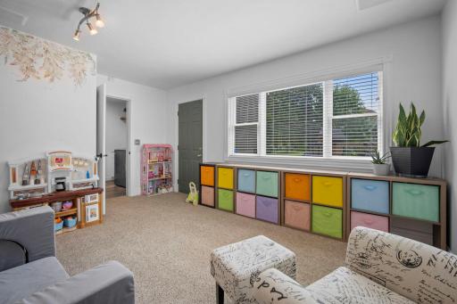 Main level flex room offering double windows that bring in a ton of natural light and a walk-out to backyard.