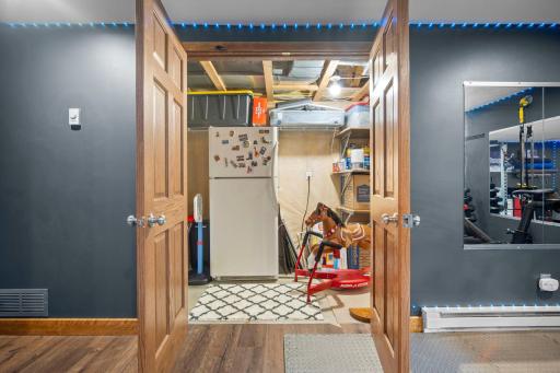 No shortage of storage space with paneled French doors to extra large storage / utility room.