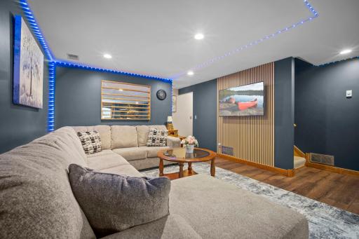 Incredible finished lower level featuring crisp, modern finishes and stylish wall panel accents.