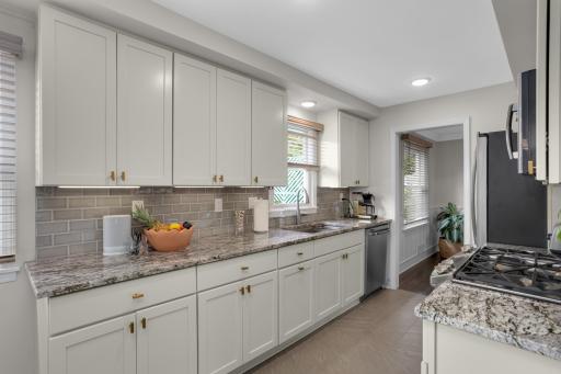 Updated Kitchen with Granite Countertops and tiled Backsplash.