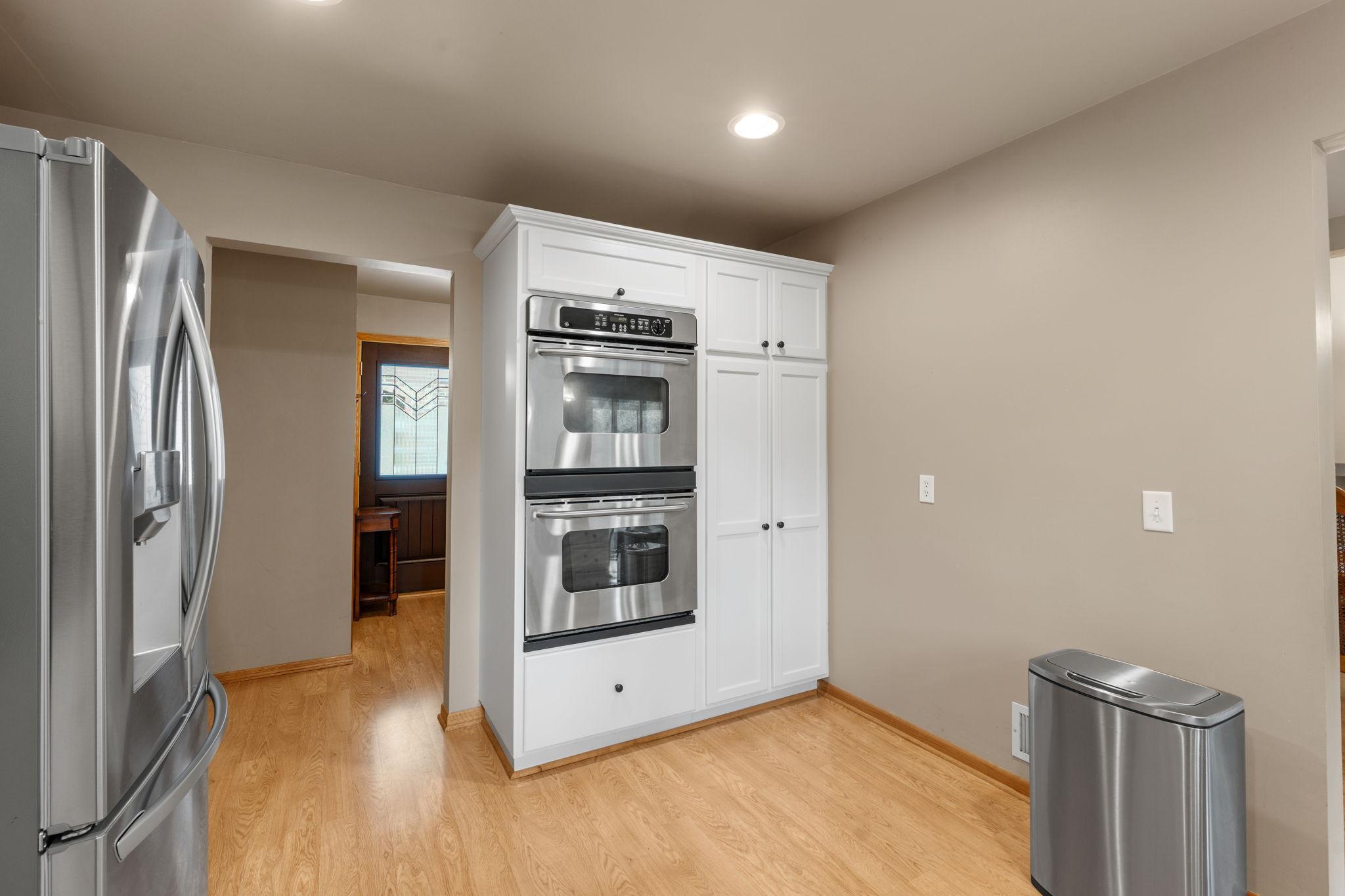 Nicely updated kitchen with custom cabinets, double wall ovens, stainless steel appliances, granite countertops, an undermount sink, and plenty of space! A window overlooks the deck and backyard.