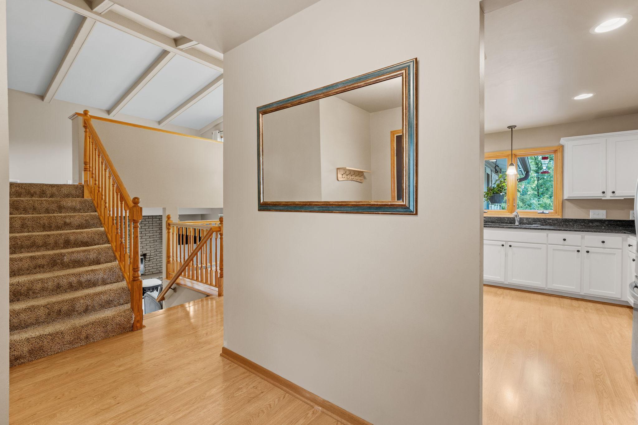 The three-level split layout makes this home functional and full of natural light, while the vaulted ceilings with wood beams bring it all together.