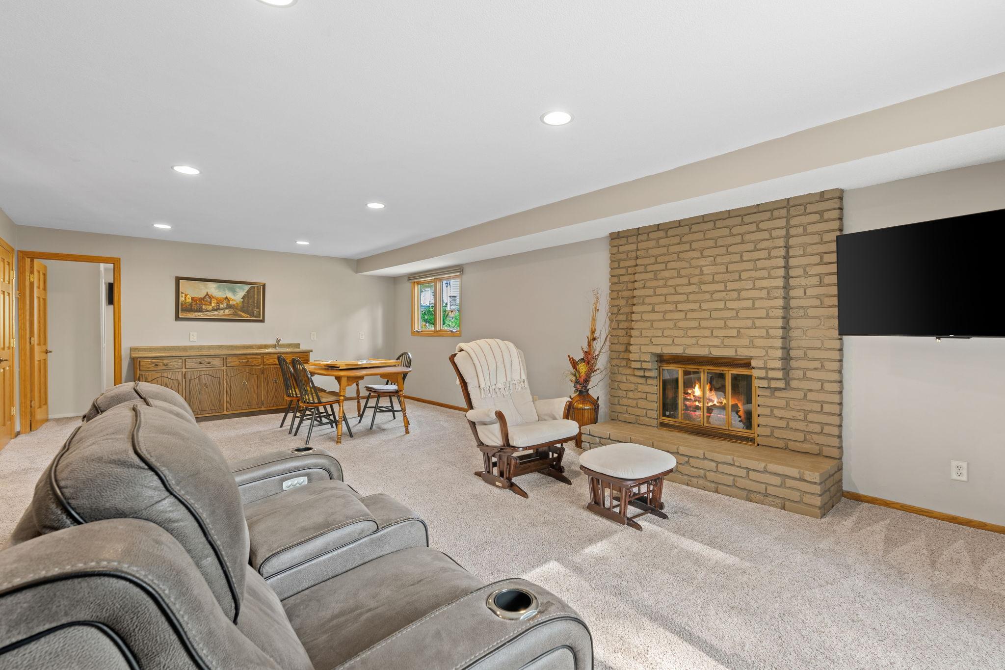 The walkout lower level has so much to offer! More living space, a wet bar, fireplace, 4th bedroom, 3/4 bathroom, and storage coming out your ears!
