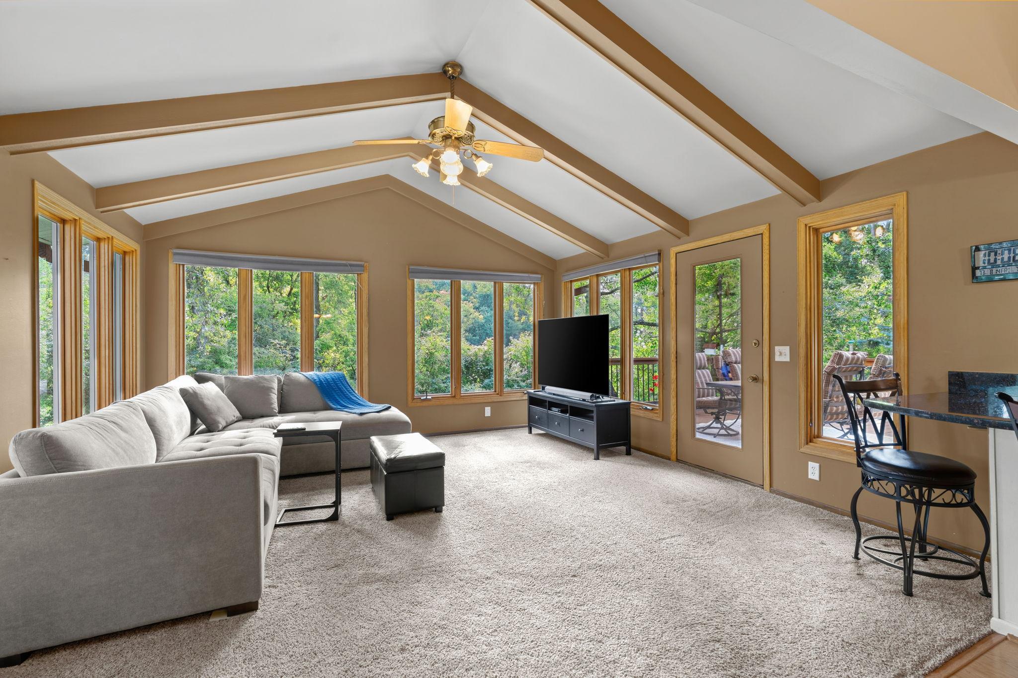 This 4-season porch really makes this home exceptional! The added space and natural light are wonderful, and it helps make the outdoor space and wraparound deck feel like an extension of the home.