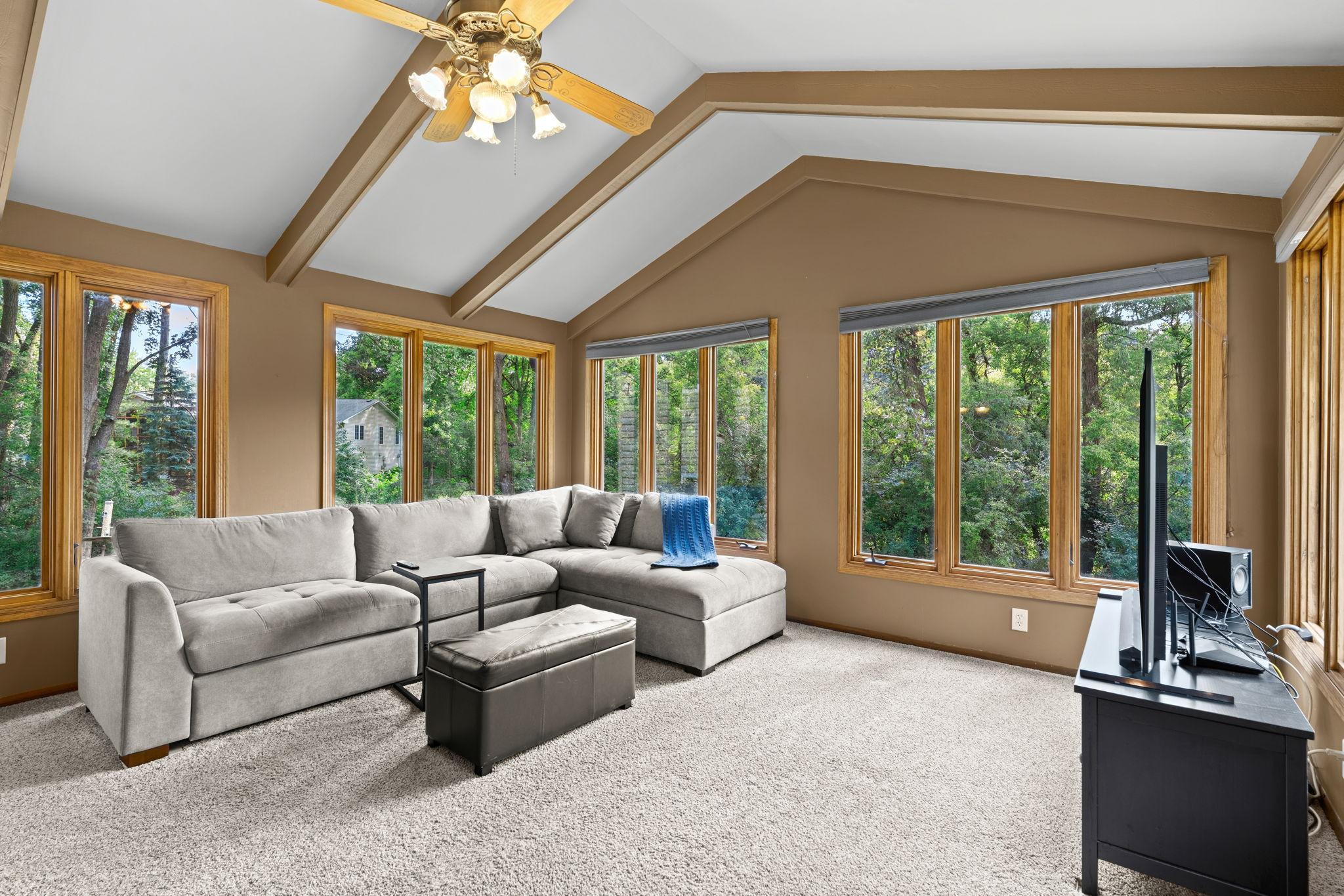 This 4-season porch really makes this home exceptional! The added space and natural light are wonderful, and it helps make the outdoor space and wraparound deck feel like an extension of the home.