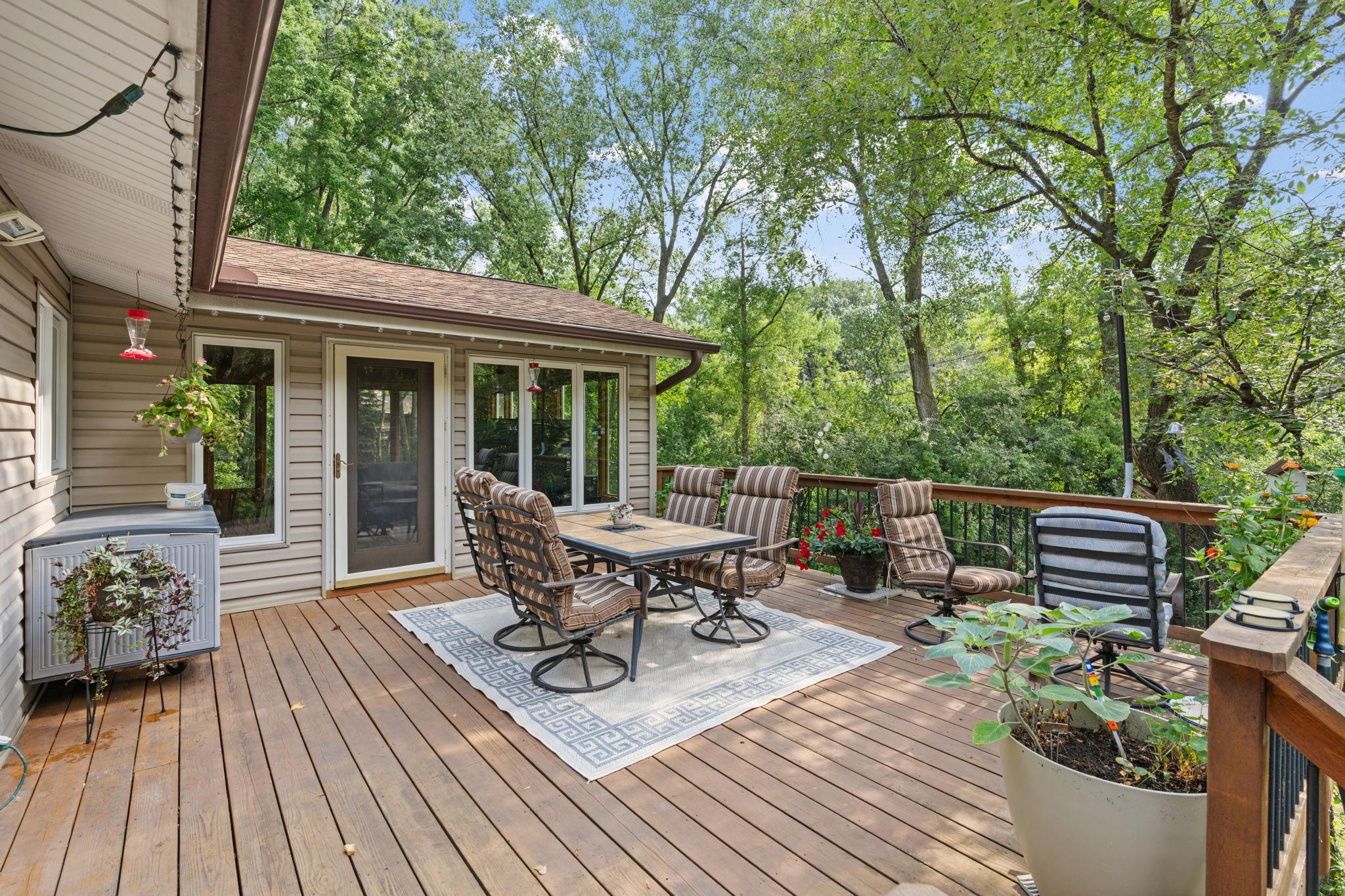 A beautiful deck in great condition overlooks the backyard and wraps around to the garage and driveway, adding extra convenience.